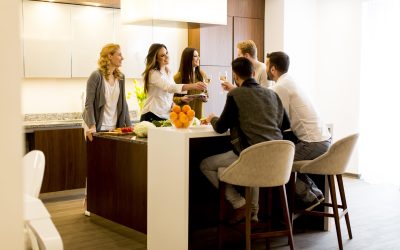 Group of young friends toasting with white wine at dinner